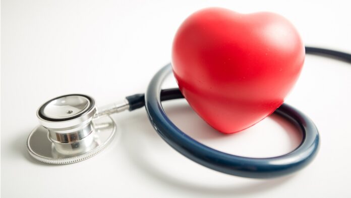 Red heart with stethoscope on white background